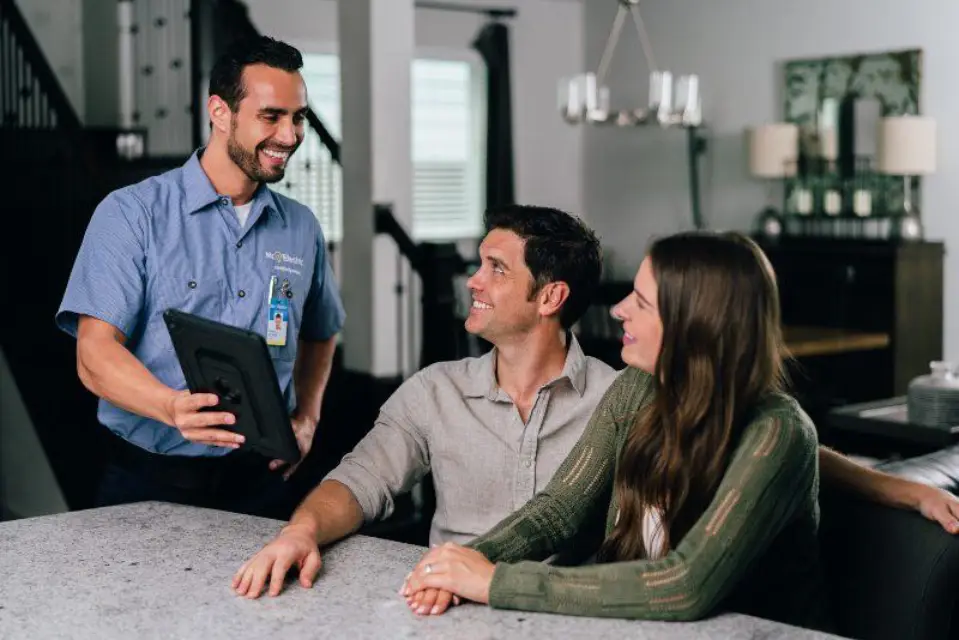Mr. Electric electrician showing customer surge protector options.
